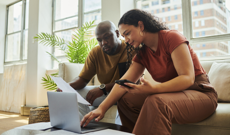A couple reading the terms of a CD investment.