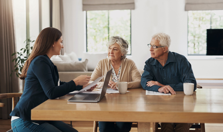 A couple discusses retirement plans with their advisor.