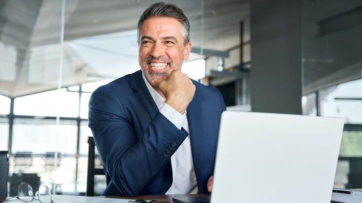 A financial advisor smiles during a wealth management meeting with a client.