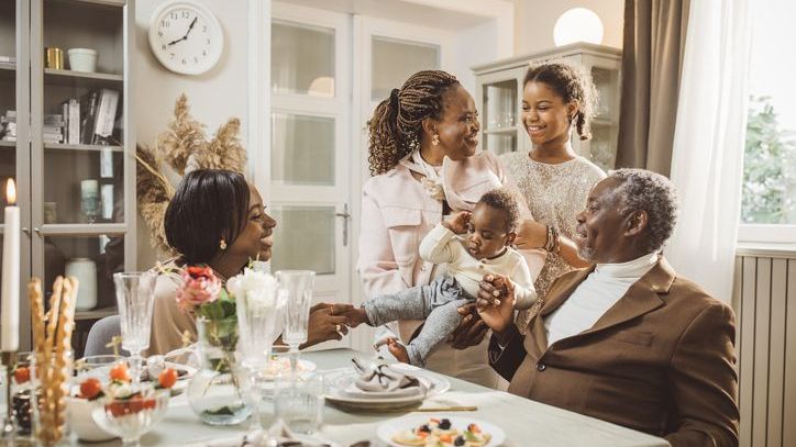 Three generations of a wealthy family gathers around the dinner table.