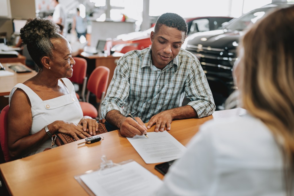 A mother and son selling the car of a deceased relative.