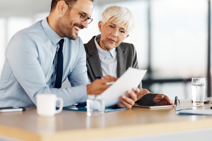 A financial advisor helping a client calculate a return on invested capital (ROIC).