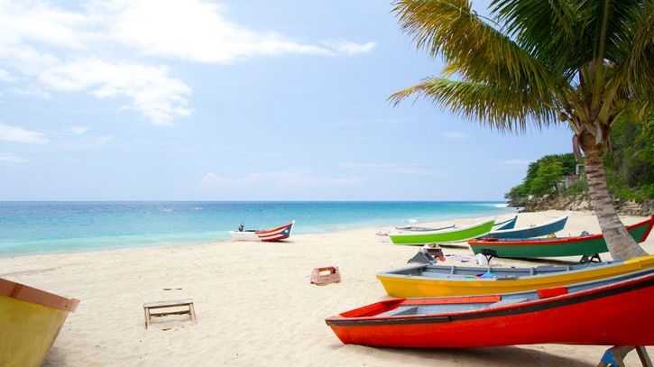 Boats sit on an empty beach in Puerto Rico.