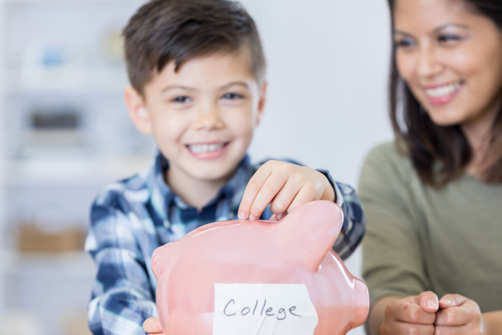 A child putting away money symbolically for college.