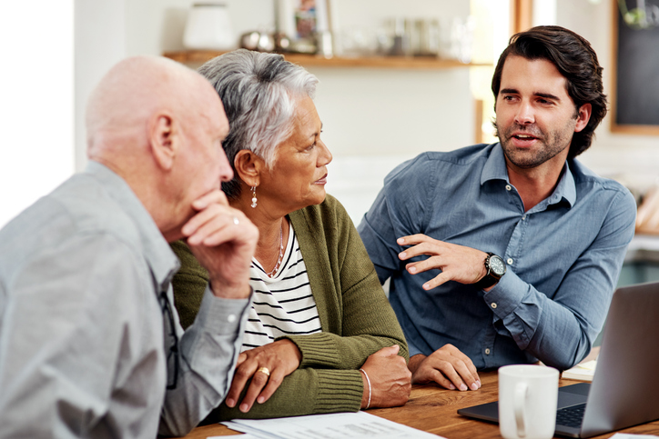 A senior couple reviewing their estate plan with a financial advisor.