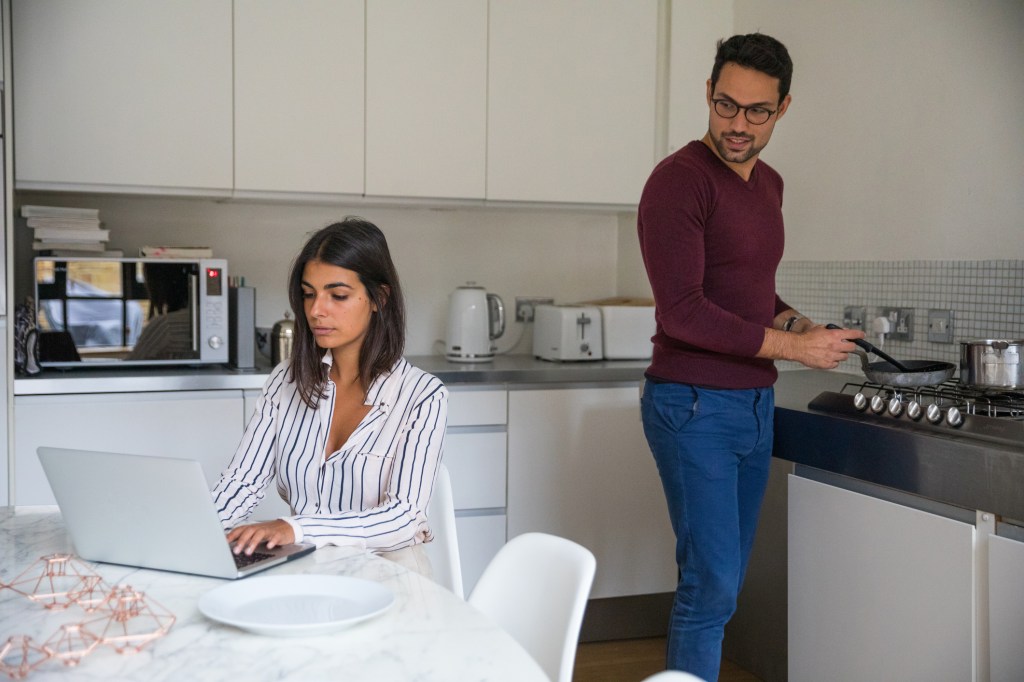 A couple discussing the benefits and drawbacks of digital investments.