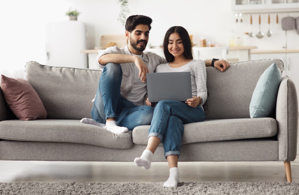 A couple researching the benefits and drawbacks of a rent-to-own arrangement.