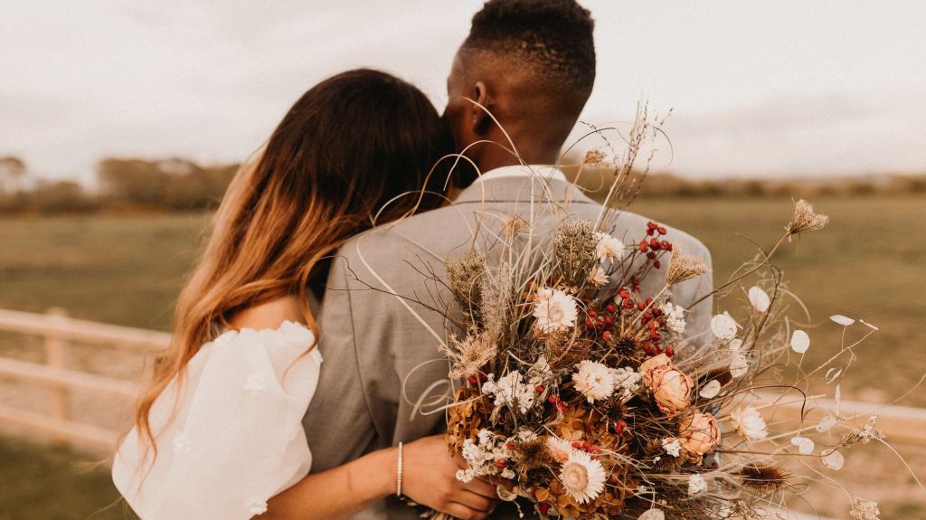 A couple embraces following their wedding ceremony.
