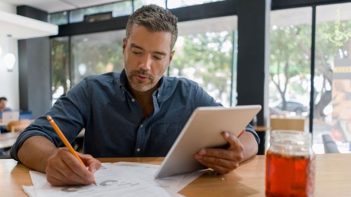 A real estate investor works on his business plan in a cafe.