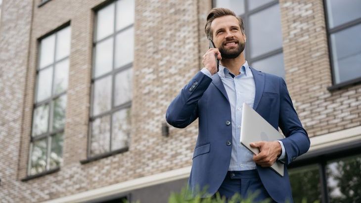 A real estate investor makes a call after touring a commercial property that's for sale.