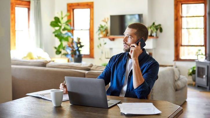 A real estate investor speaks with the property manager of several rental properties he owns in a different state.