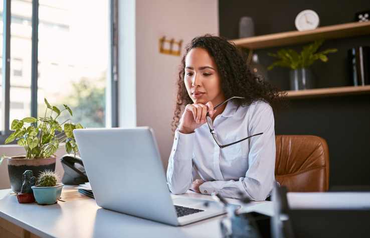 A woman researches books on building wealth.
