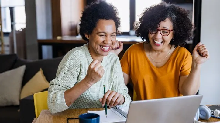Two women look over their savings.
