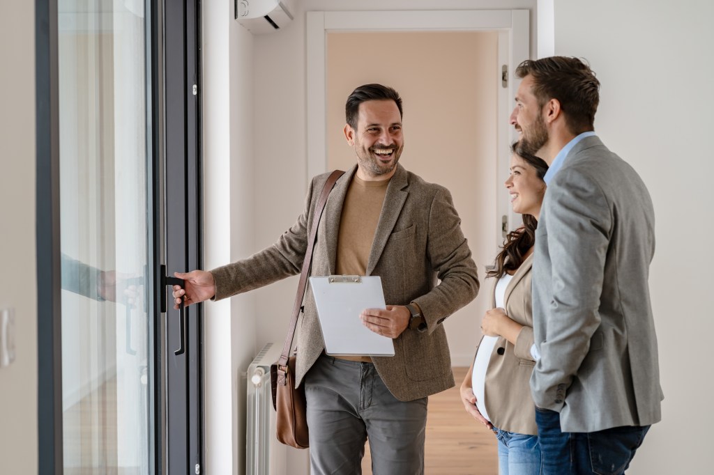 A property manager showing an apartments to prospective tenants.
