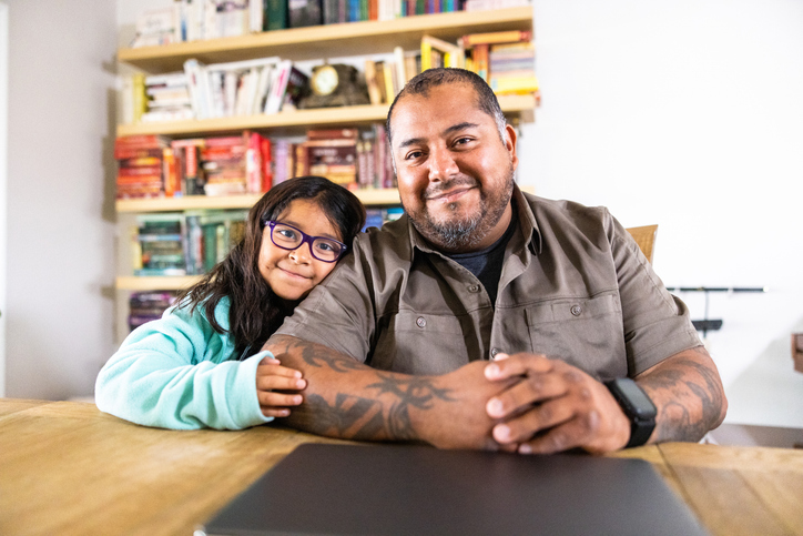 A veteran posing with his daughter after creating an estate plan.