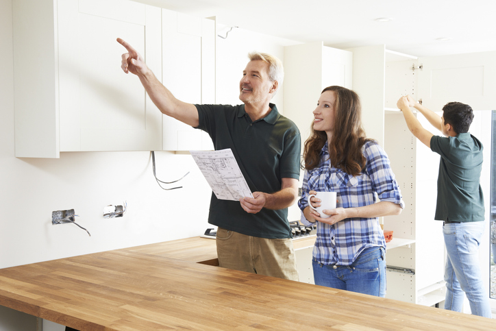 A couple inspecting a house with the intention of flipping it.
