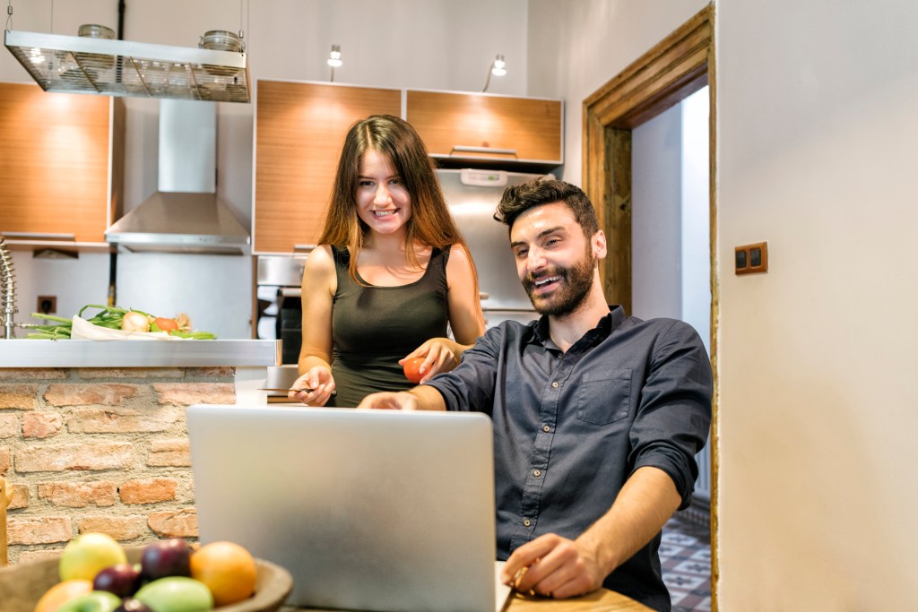 A couple reviewing the performance of their digital investments.