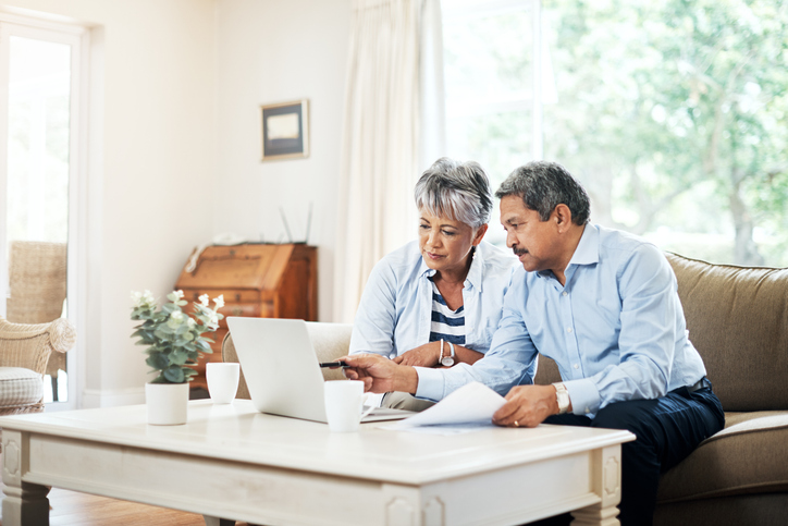A couple signs up for a long-term care insurance policy.