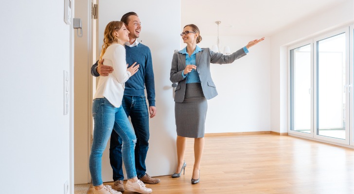 A tenant services representative shows a vacant apartment an interested couple.