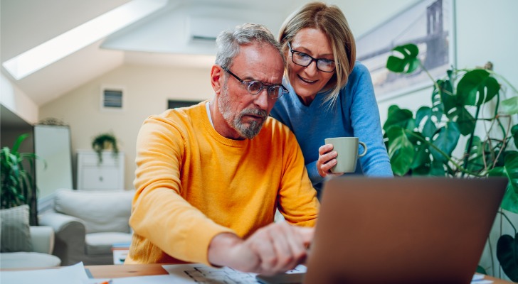 A couple looks at their retirement account balances to determine how much they can afford to withdraw on an annual basis.