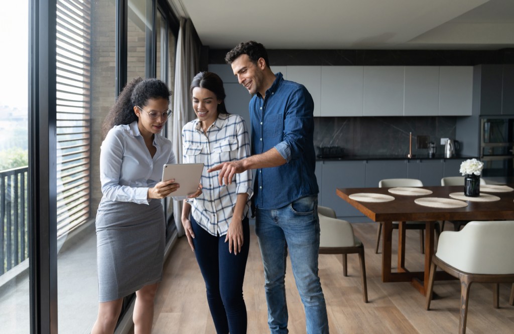 Real estate investors touring a potential investment property with an agent.