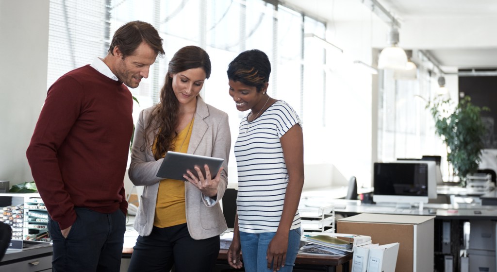 A couple looking at investment properties with an agent.