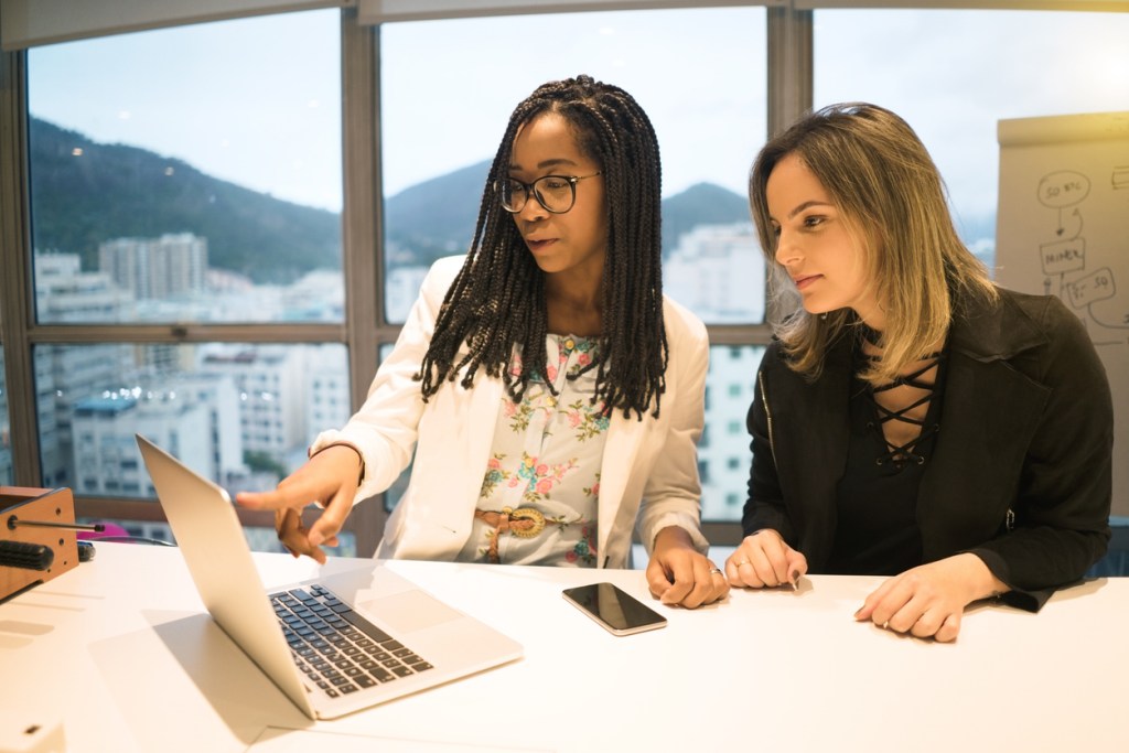 Two investors researching REITs.