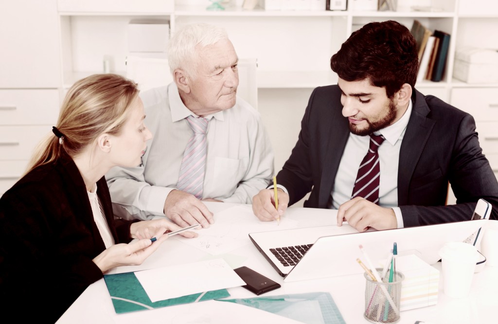A father and daughter meeting with a an advisor to review their estate plan.