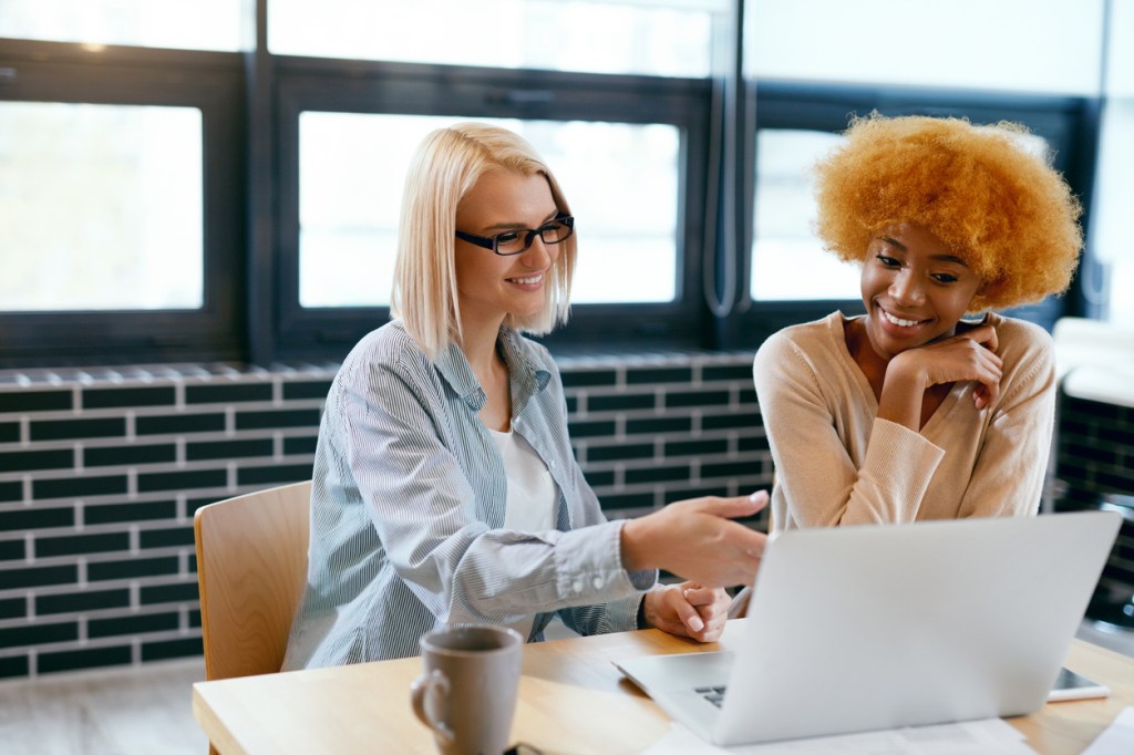 Two investors comparing gold and stock investments.