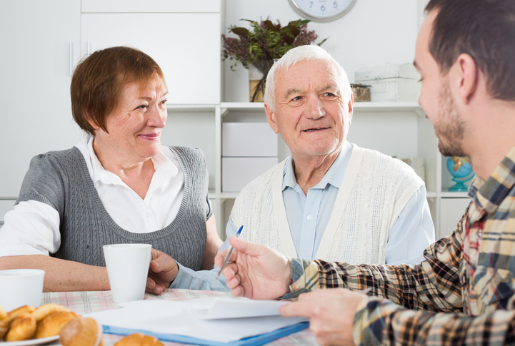 A senior couple reviewing their estate plan with a financial advisor.