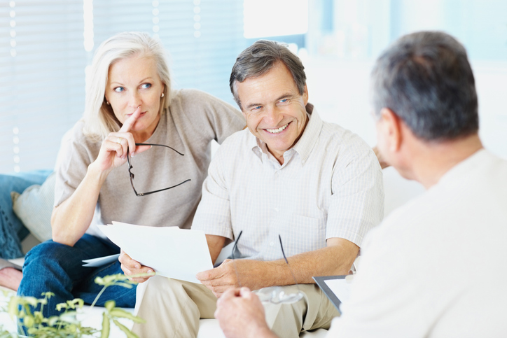 A senior couple reviewing their estate plan with a financial advisor.