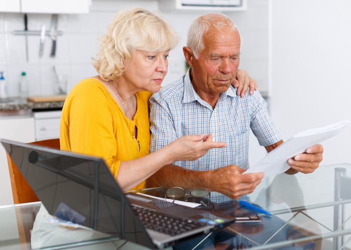 A senior couple reviewing their Social Security benefits.