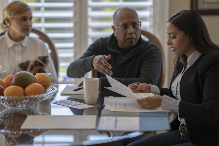 Landlords reviewing eviction documents with a lawyer.
