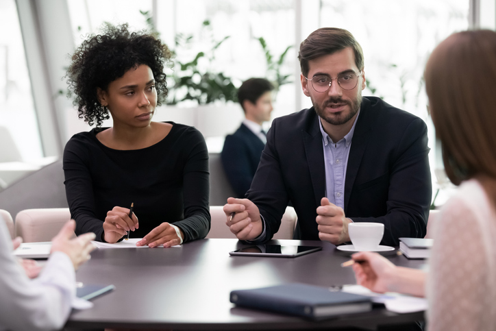 Investors meeting with an advisor to research opportunities.