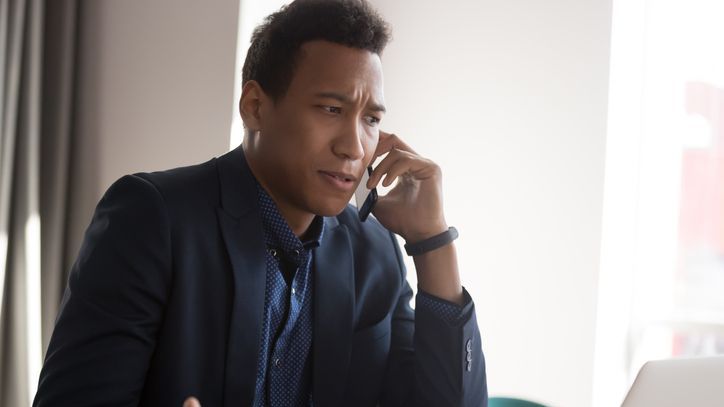 An unhappy client talks to his financial advisor on the phone.