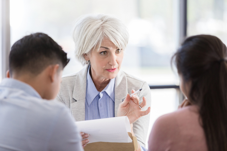 A financial advisor reviewing a portfolio with investors.