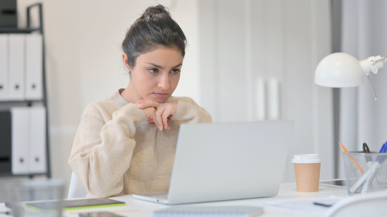 A woman reviewing a financial goal planner document.