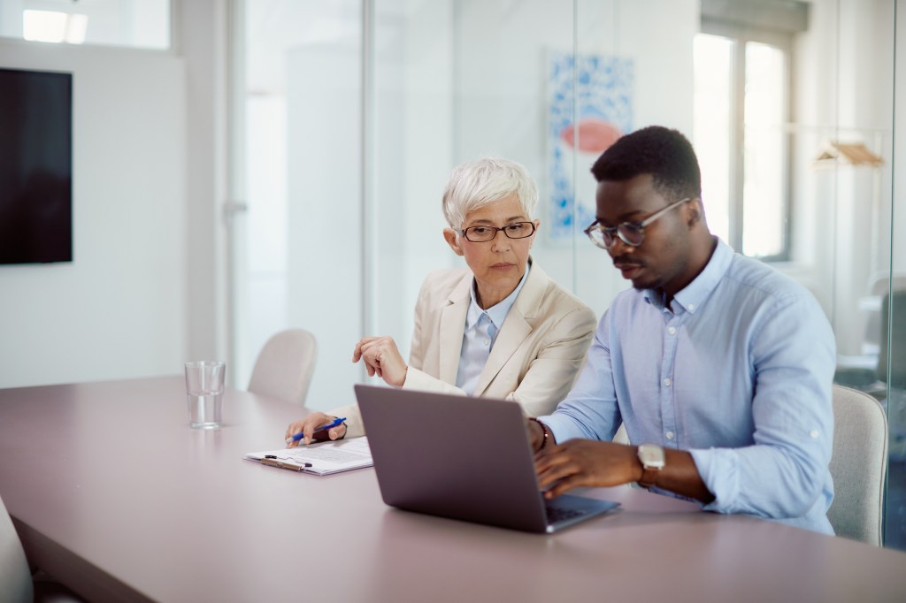 A real estate investor discussing insurance coverage with an advisor.