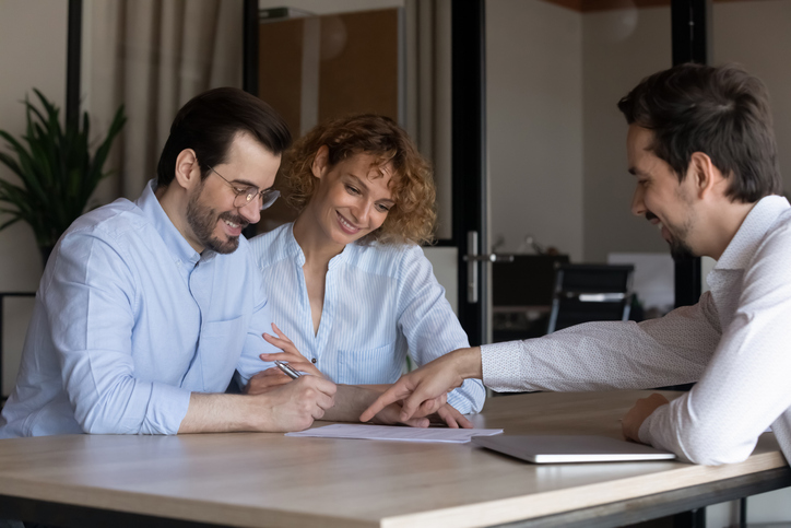 Real estate investors working with a financial advisor to create an investment plan.