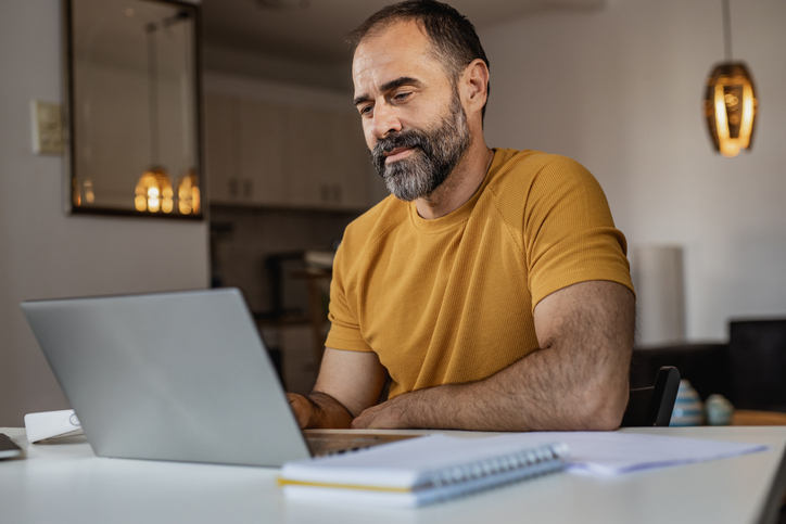 A man researching alternatives for debt consolidation without mortgage refinancing.