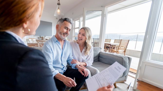 A wealthy couple meets with their financial advisor to discuss their investments in hedge funds.