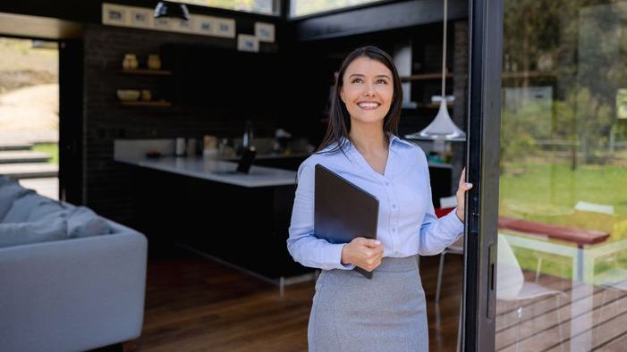 A real estate investor looks out from a home she recently purchased.