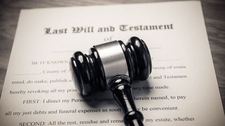 A gavel rests on top of a standard last will and testament form.