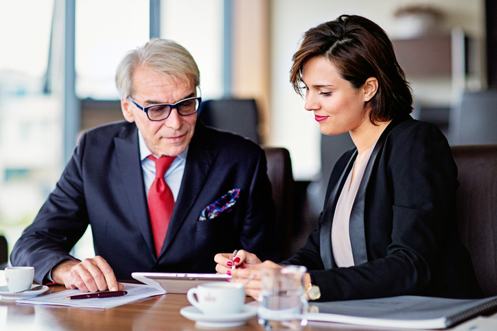 A senior client reviewing his retirement plan with a financial advisor.