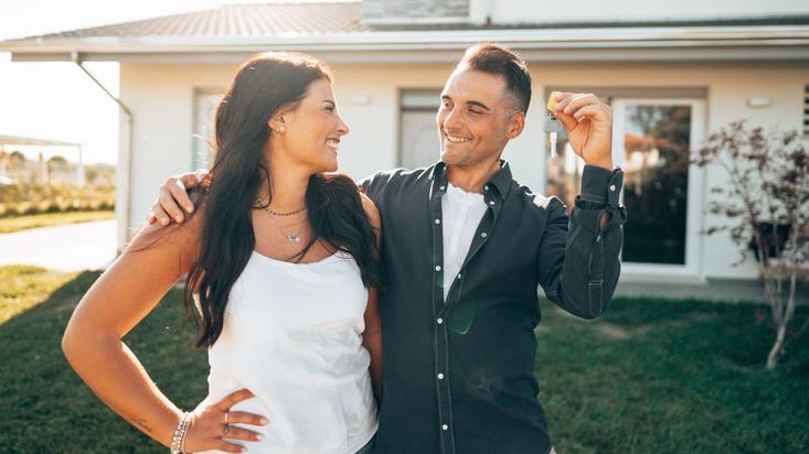A 30-year-old couple celebrates after getting the keys to their first home together.