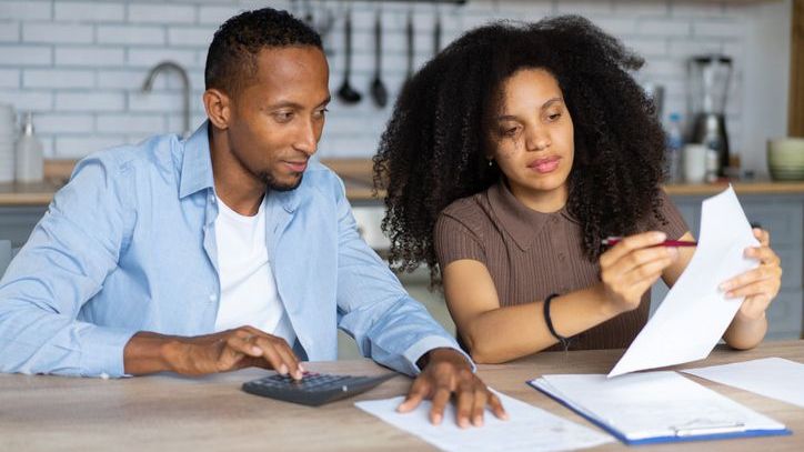 A couple goes over the rent payments they've collected from their investment property.