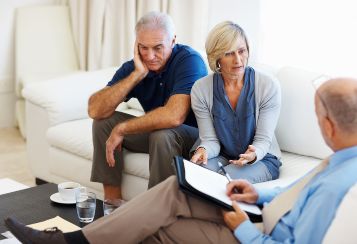 A financial advisor working with a couple to resolve an estate planning issue.