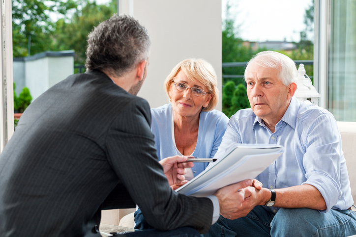 A senior couple getting estate planning advice from a probate lawyer.