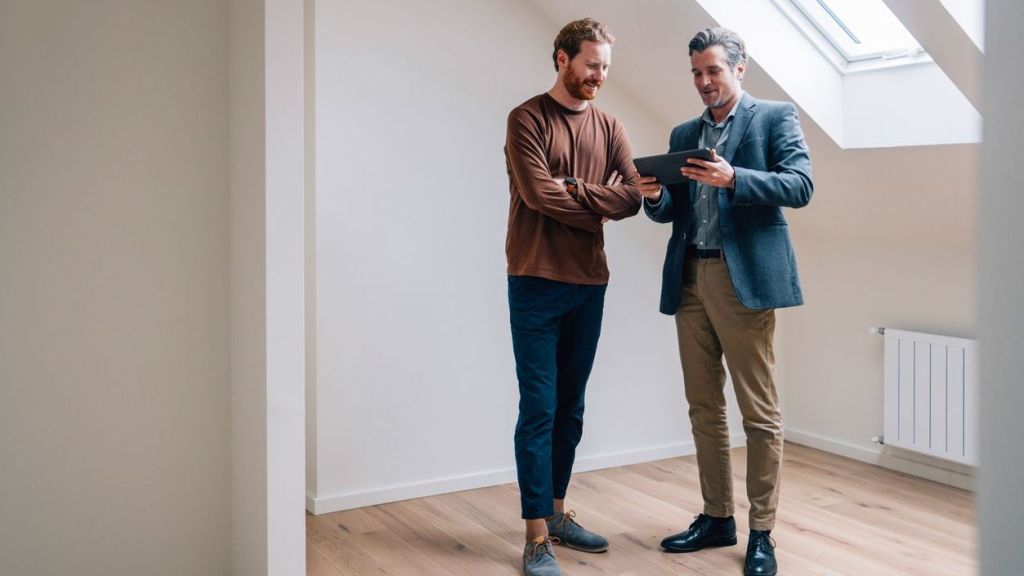 Two real estate investors go over the numbers on a home that they're considering purchasing together.