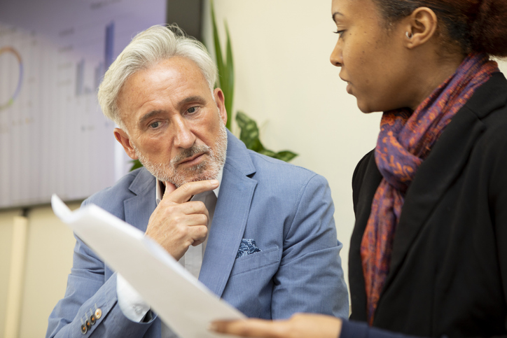 An advisor explaining the benefits and drawbacks of holding long-term stocks.